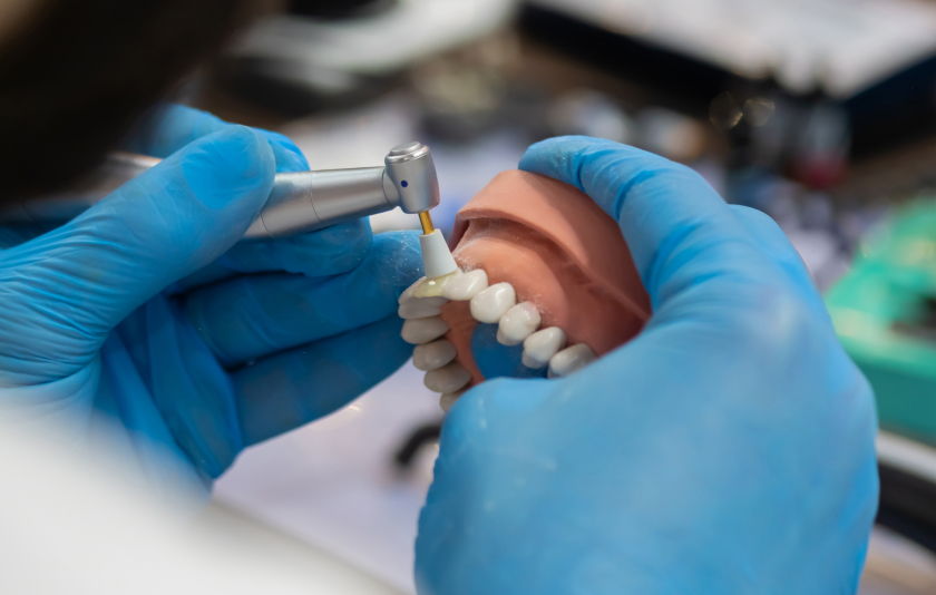 Dental technician fixing dentures